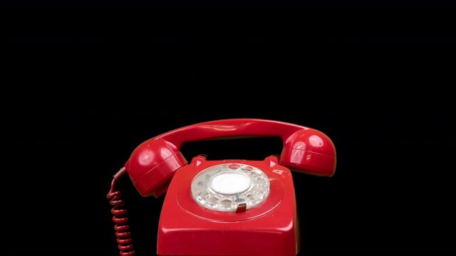 A red classic rotary telephone stop motion