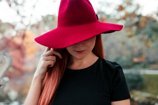 Close-up of mid adult woman wearing red hat in park