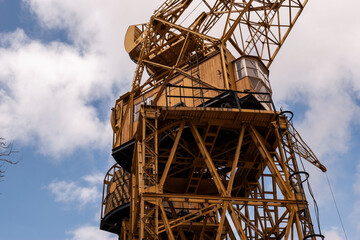 A crane in production. Bottom view of a large crane against the sky