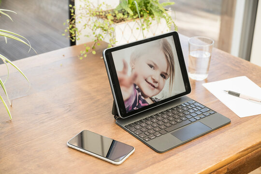 Photograph of girl on digital tablet at home