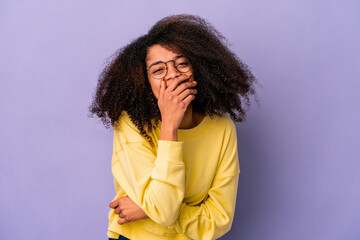 Young african american curly woman isolated on purple background laughing happy, carefree, natural emotion.