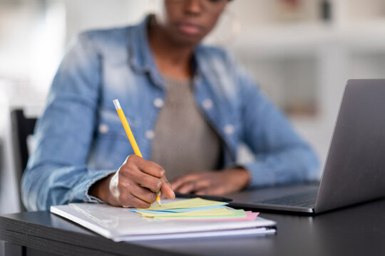 Woman Writing On Paper At Home