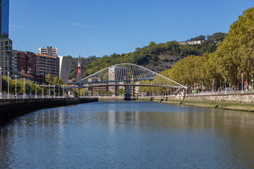 view of the Zubizuri bridge from the estuary of Bilbao on a sunny day with blue sky, Bilbao, Bizkaia, Basque Country, Spain, Europe