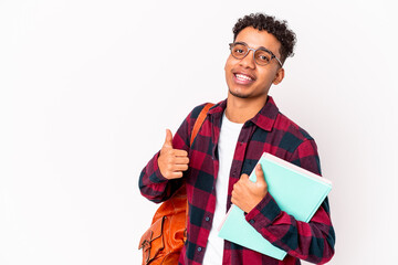Fototapeta premium Young african american student curly man isolated holding books smiling and raising thumb up