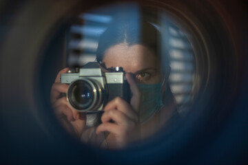 The photographer takes pictures with a retro camera. A look through the lens concept - 410279849