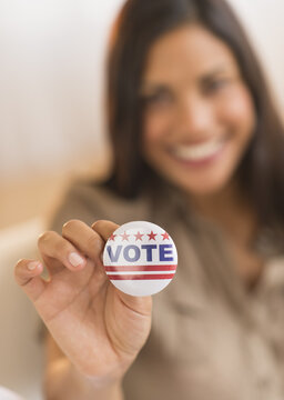 Woman holding vote button