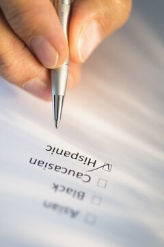 Close-up of hand filling out form