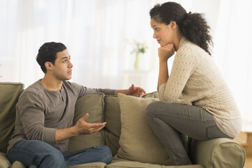 Couple talking on sofa