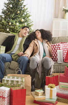 Couple with Christmas presents in living room