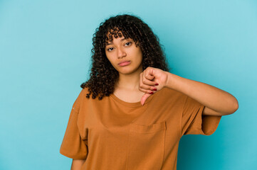 Young african american afro woman isolated showing a dislike gesture, thumbs down. Disagreement...