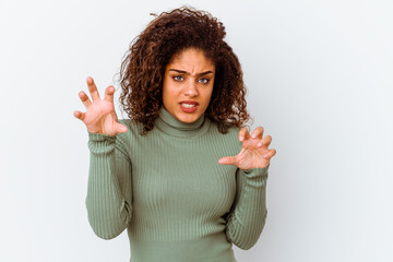 Young african american woman isolated on white background upset screaming with tense hands.