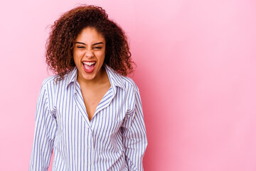 Fototapeta premium Young african american woman isolated on pink background shouting very angry, rage concept, frustrated.