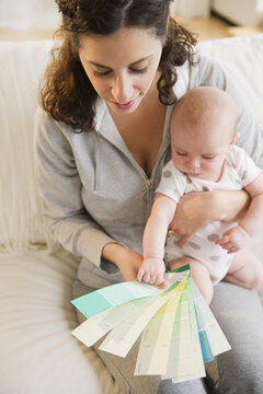 Mother and baby boy (2-5 months) checking colors samples