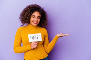 Young African American woman holding a Help placard isolated on purple background showing a copy...
