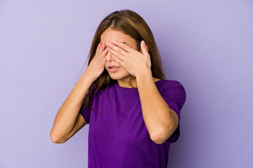 Young skinny caucasian girl teenager on purple background afraid covering eyes with hands.