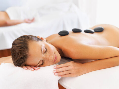 Woman getting lastone therapy in spa