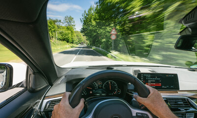 hands of car driver on steering wheel, road trip, driving on highway road