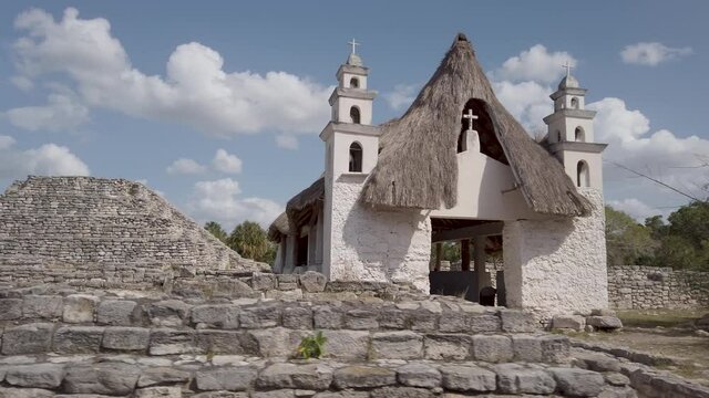 Steadycam motion of Xcambo Mayan ruins and catholic church with grass roof located between Progresso and Telchac Puerto, Mexico.