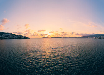 Beautiful sunset, aerial view of the beach, acapulco city seen from above. Travel and vacation concept. Colorful sunset on the beach