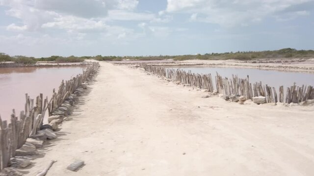 Salt ponds with pink water that the Mayans have mined since ancient time.