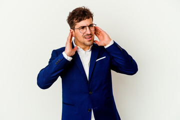 Young business caucasian man isolated on white background covering ears with fingers, stressed and desperate by a loudly ambient.