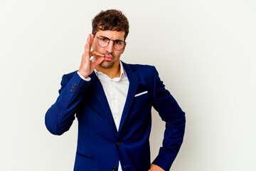 Fototapeta premium Young business caucasian man isolated on white background with fingers on lips keeping a secret.