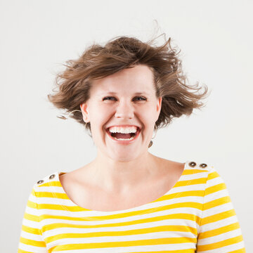 Studio portrait of woman laughing