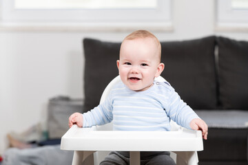 Portrait of Young Baby Boy in High Chair