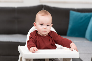 Beautiful Child Sitting in High Chair