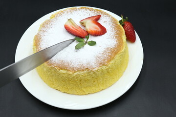 Homemade Fluffy Japanese Cheesecake, strawberries, knife