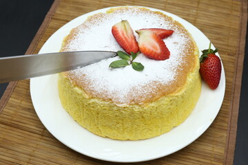 Homemade Fluffy Japanese Cheesecake, strawberries, knife