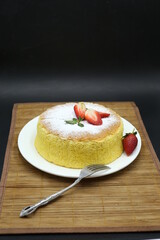 Homemade Fluffy Japanese Cheesecake, strawberries, knife