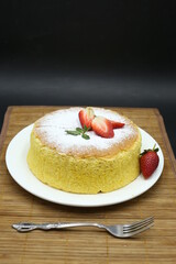 Homemade Fluffy Japanese Cheesecake, strawberries, knife