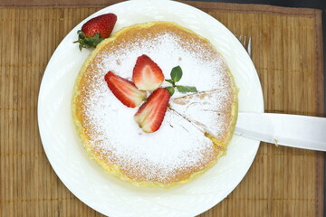 Homemade Fluffy Japanese Cheesecake, strawberries, knife