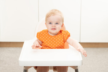 Baby Girl Sitting on Chair Waiting for Meal