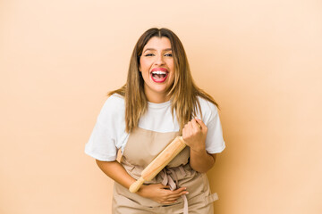 Young indian pastry chef woman isolated laughing and having fun.