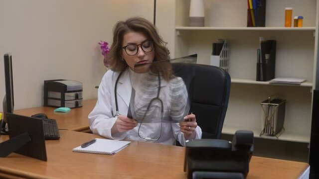 Doctor reads email, consults notes and chest x-ray then looks at camera and shakes head. Very sick patient