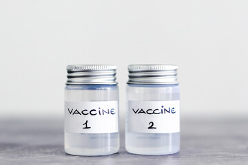 covid-19 vaccine race and immunisation against the pandemic, ampoules with Vaccine 1 and Vaccine 2 labels side by side