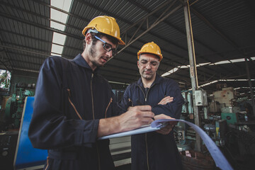 workers talking and laughing at a factory. workers at an industrial plant