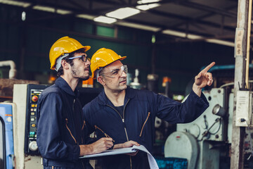 workers talking and laughing at a factory. workers at an industrial plant