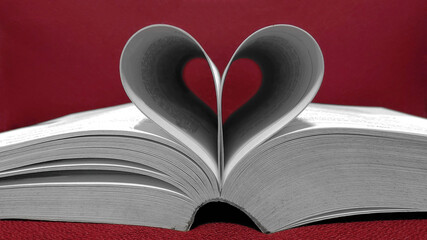 Soft focus of Books in a heart shape on red background