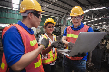 worker Industrial Engineers Talk with Factory Worker while Using Laptop. industrial worker is working. technician engineer and mentor checking process. machine metalworking industry concept copyspace