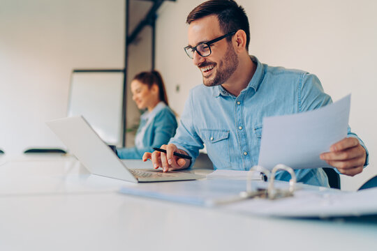 Businessman doing paperwork in the office - Powered by Adobe