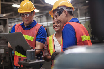worker Industrial Engineers Talk with Factory Worker while Using Laptop. industrial worker is...