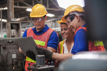 worker Industrial Engineers Talk with Factory Worker while Using Laptop. industrial worker is...