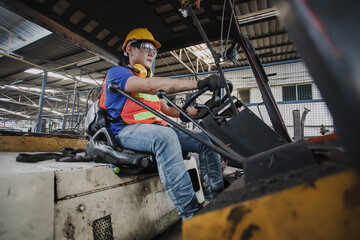 Fototapeta na wymiar worker forklift driver working in industrial factory or warehouse. worker Asia