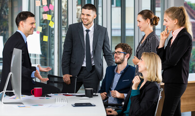 Group of businesspeople team sitting in conference together in an office with intimate manner. Idea for a good relationship of teamwork in business