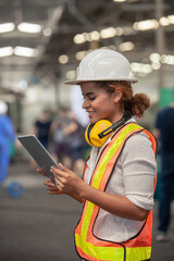 Engineer Female in using Tablet in Foundry worker in factory on the machine. portrait of an industrial Femal engineer with tablet in a factory.