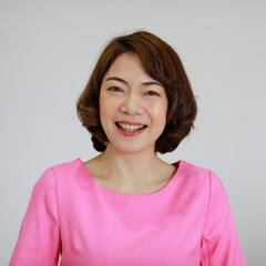 Portrait of a young and beautiful Asian woman with self-confident pose on white background