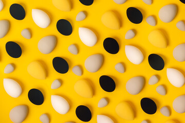 Pattern of makeup beauty sponges and on a bright yellow background